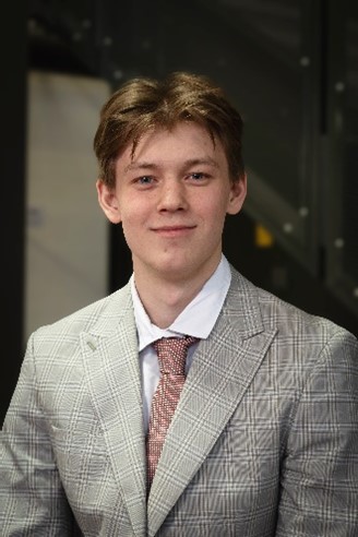 A professional photo of Andrii in a suit and tie.