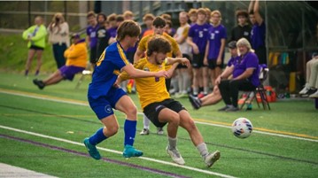 An action photo of Rodrigo on the soccer field going after a soccer ball during a game.