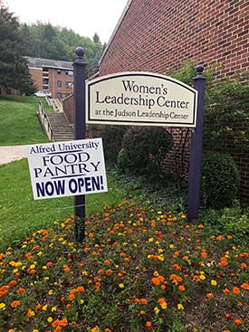 Women's Leadership Center sign with a food pantry poster on it