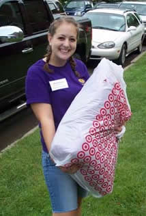 Student smiling while holding a Target Plastic Bag